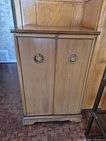 Full frontal view showing double doors and ring pulls