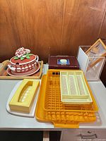 Overall lot with casserole, trays, dish rack, tissue box cover, boxed cheese plate