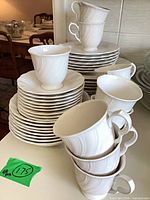Stacked dinnerware showing cups, plates and saucers