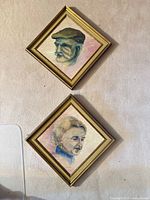 Front view of both framed portraits hung on wall