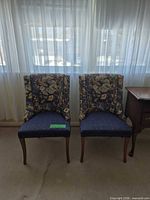 Front view of both navy floral accent chairs side by side