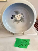 Top view of porcelain bowl showing floral motif and size reference