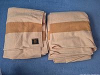 Both folded wool blankets showing color and edges