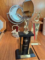 Group view showing both vanity mirrors and front bowling trophy on black base