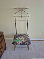 Full view of valet stand front showing seat cushion upholstery and frame