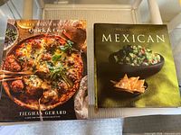 Top-down view of two hardcover cookbooks: Half Baked Harvest Quick & Cozy and Williams-Sonoma Mexican