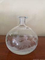 Front view of clear etched glass decanter showing deer scene
