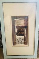 Front view of framed photograph under glass
