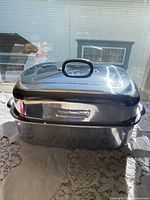 side view of roaster with lid showing KitchenAid badge