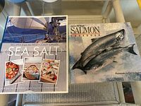 Front covers of both seafood cookbooks showing titles and authors