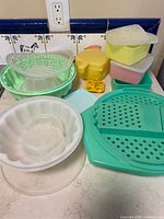 group shot showing variety of Tupperware pieces, colors and condition