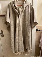 Front view of wool wrap hanging to show length and collar