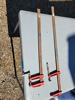 Two long bar clamps on tabletop