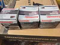 Three boxed Kawasaki oil filters on carton