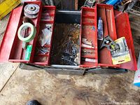 Open toolbox showing red trays and assorted contents