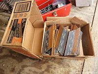 Open case showing multiple collated nail strips inside original cardboard box