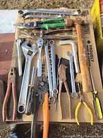 Full layout of mixed hand tools on cardboard