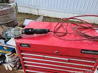 Full view of trouble light on toolbox showing handle, cage and cord