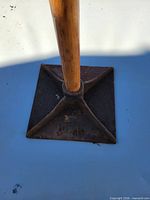 Square cast-iron base with wooden handle connection