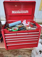 Open toolbox showing Mastercraft branding, hinged lid and misc contents