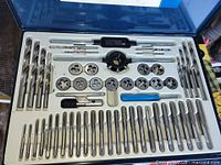Open case showing full 52-piece tap and die set arranged in white tray