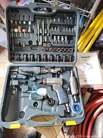 Closed-view of entire open case showing pneumatic tools and accessories