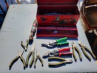 overview of toolbox, air tool and pliers laid out
