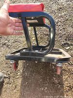 Side view showing steel frame, seat cushion and casters