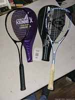 Both squash rackets with covers displayed on table