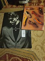 Cambridge and Naturalizer displays lying side by side on rug