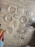 All fourteen clear glass pieces laid out on floor