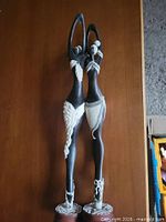 Full view of both ebony sculptures standing side by side