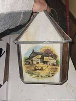 Front view showing Currier & Ives barn scene panel, slag glass roof and metal caming