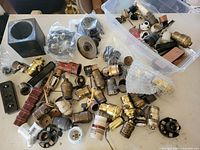 Table spread showing majority of brass, bakelite, porcelain sockets and fittings