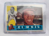 Card front in protective sleeve showing player images and team details