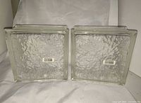 Front view of both glass blocks showing texture and size