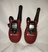 Front view of both red Motorola T5700 radios standing upright