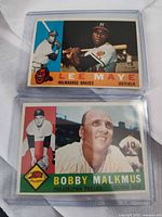 Front view of both cards in sleeves