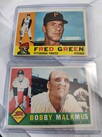 Fronts of both 1961 Topps cards in plastic sleeves