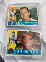 Front view of both Topps cards in sleeves showing player names and teams