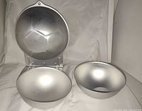 Overall view showing patterned hemisphere attached to bracket and two smooth hemispheres