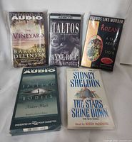 Five sealed audiobook cassette sets laid out