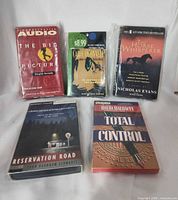 Group shot of all five sealed audiobook cassettes