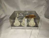 sealed box containing four white Christmas tree tealight candles