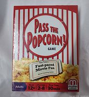 Front of sealed Pass the Popcorn! game box showing title and shrink-wrap