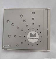 Front view of square Monster portable speaker showing logo and perforations