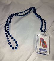 Full view of necklace laid out showing beads and pendant