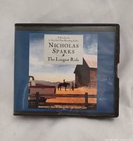Front of audiobook case showing title, author, reader information