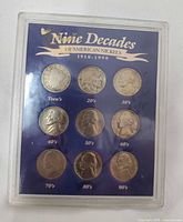 Front view of plastic display showing all nine nickels and title banner