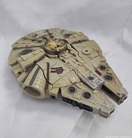 Top angled view of Millennium Falcon toy showing overall design and wear
